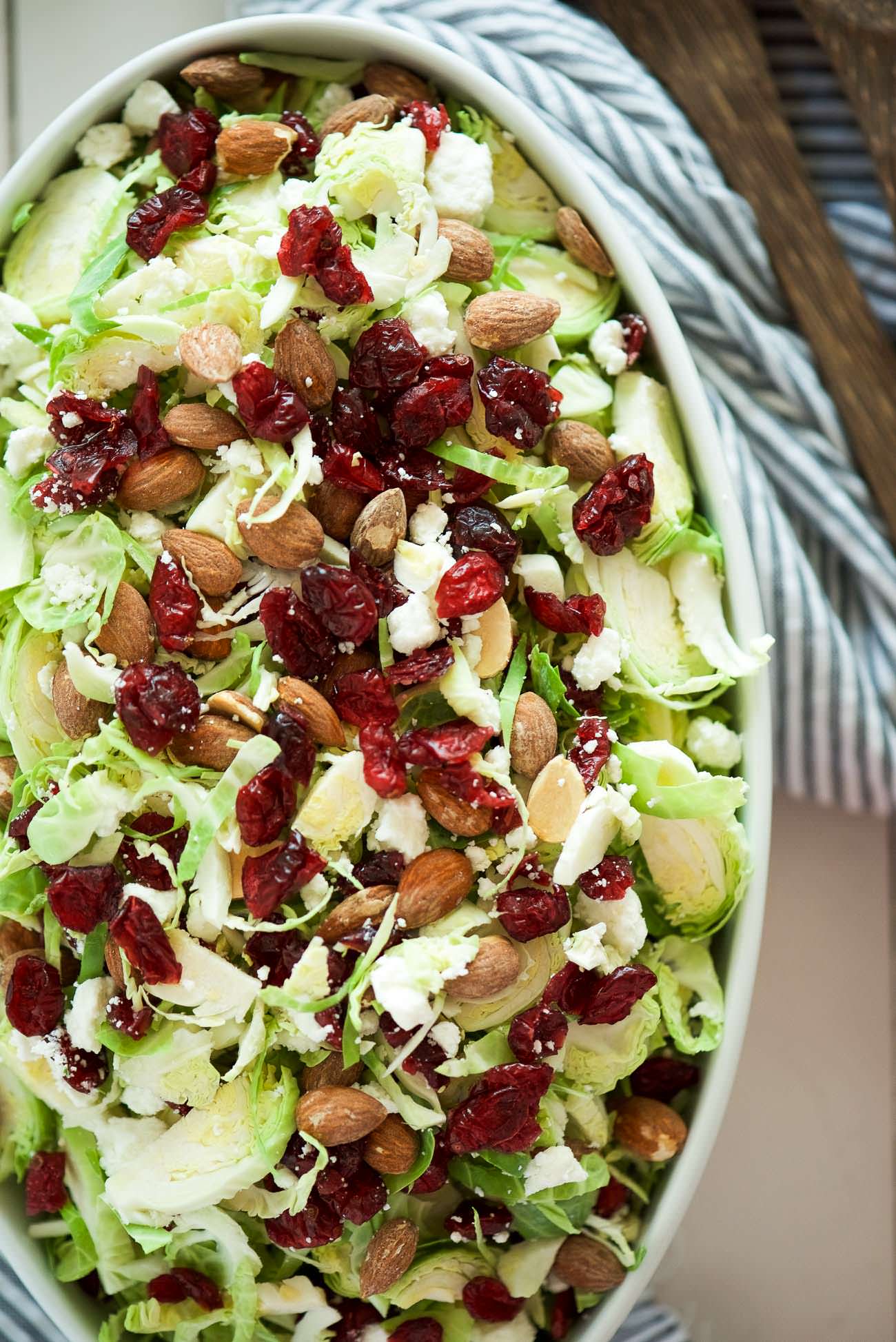 Spring Shaved Brussels Sprout Salad with Lemon Poppyseed Dressing is a fast and light salad that is full of tart cranberries, creamy goat cheese and salty almonds! And tossed in a flavorful, homemade citrus poppyseed dressing!