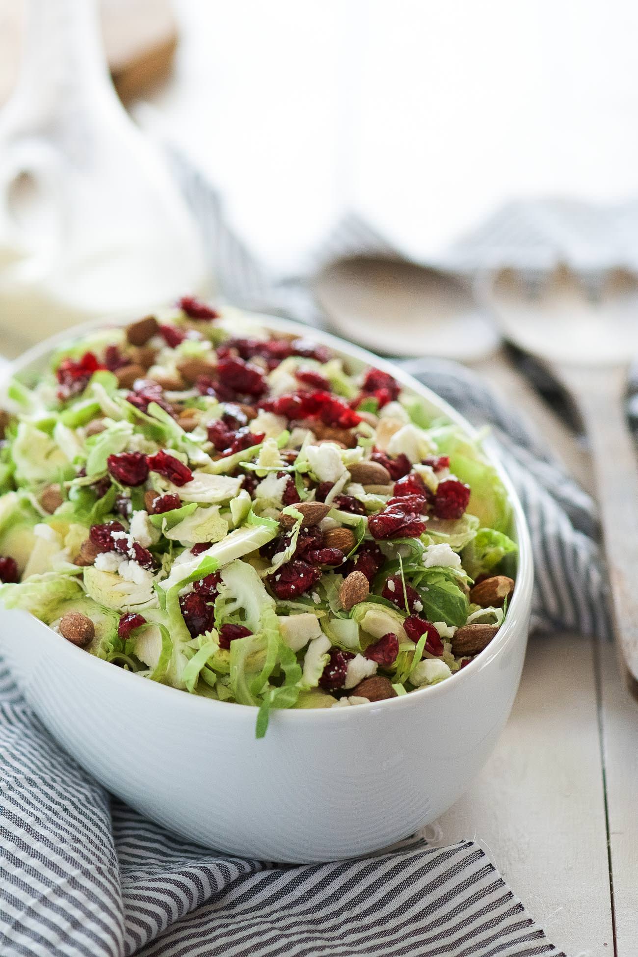 Spring Shaved Brussels Sprout Salad with Lemon Poppyseed Dressing is a fast and light salad that is full of tart cranberries, creamy goat cheese and salty almonds! And tossed in a flavorful, homemade citrus poppyseed dressing!