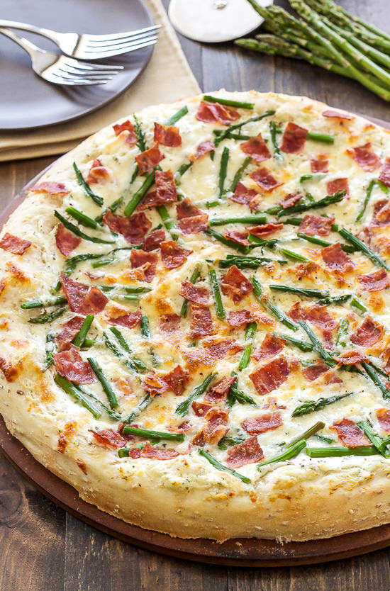 A delicious spring inspired pizza topped with asparagus, bacon, and herbed goat cheese!