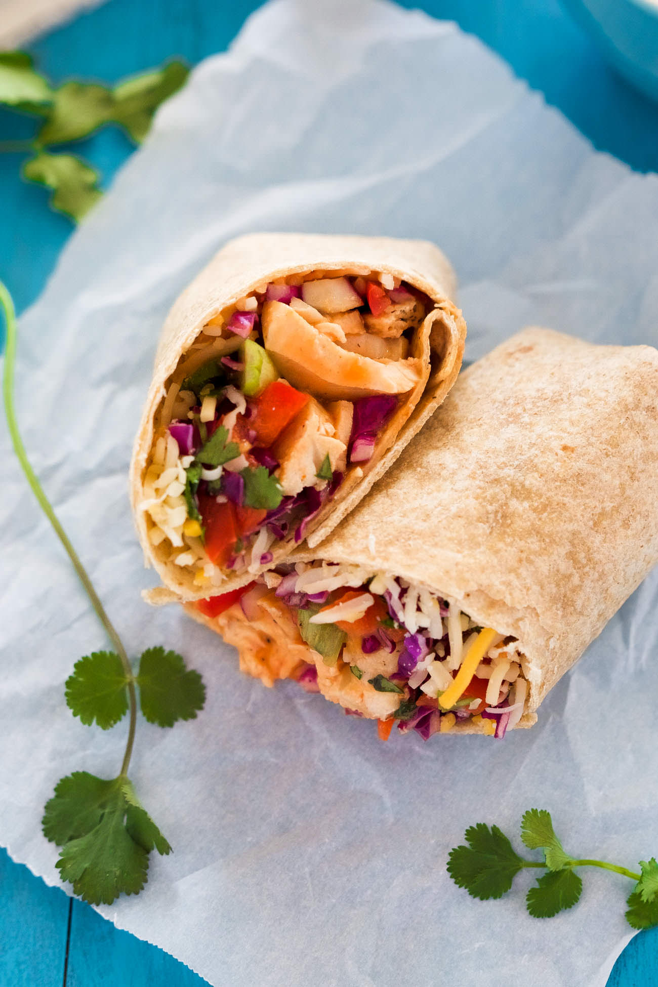 These Hot & Spicy Thai Chicken Wraps is the perfect quick dinner or lunch! Filled with a spicy thai slaw, grilled chicken, pepper jack cheese and drizzled with an addicting Sriracha honey aioli!
