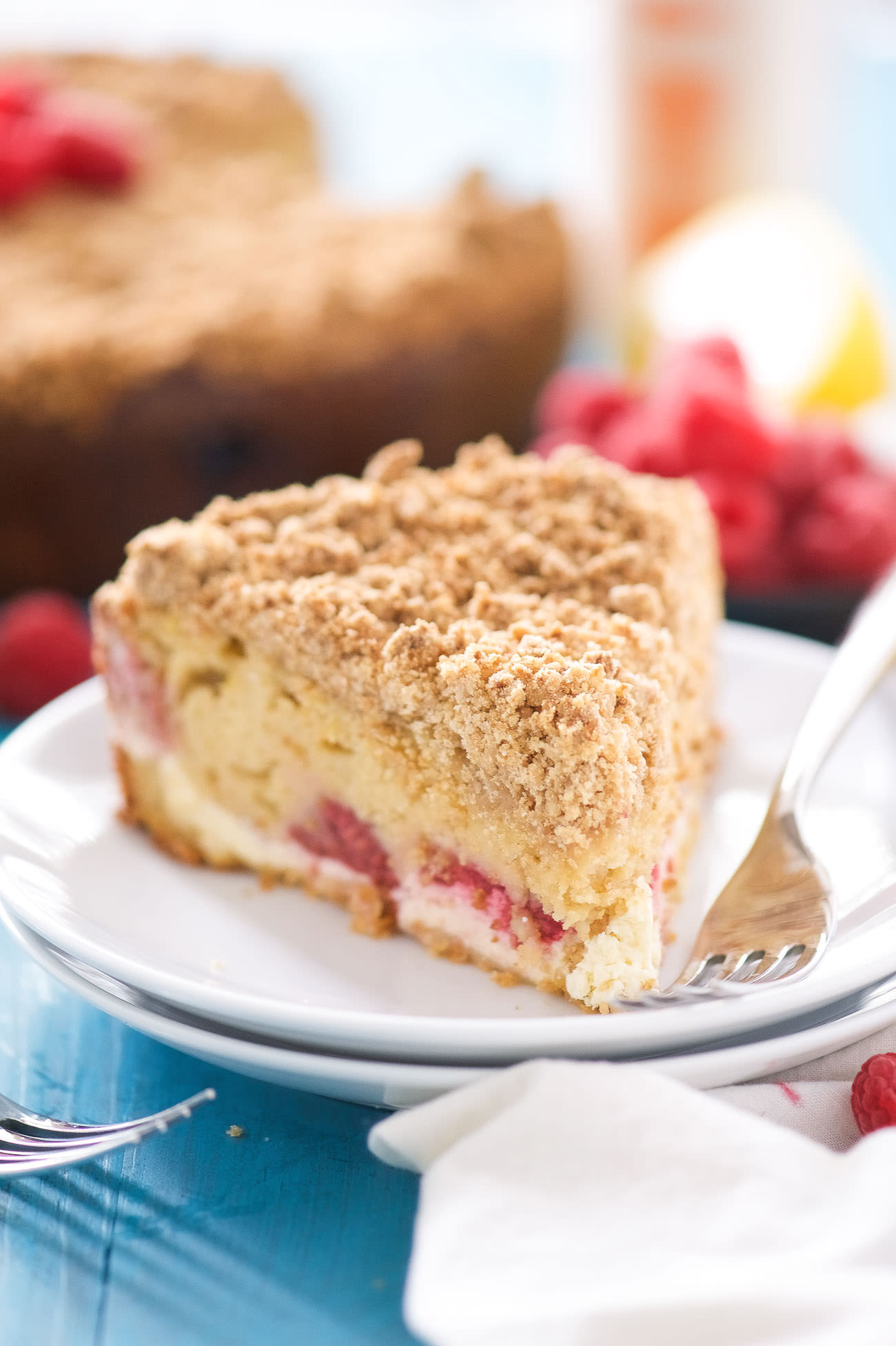 This Lemon Berry Cream Cheese Coffee Cake is the answer to your brunch prayers! A lightened up coffee cake that is bursting with spring flavors, filled with a creamy cream cheese swirl and a thick crumb layer!