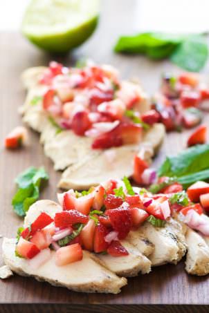 Balsamic Grilled Chicken with Strawberry Mint Salsa is a fresh spin on dinner! Fresh strawberries, mint and lime make the ideal summer topping for juicy grilled chicken!