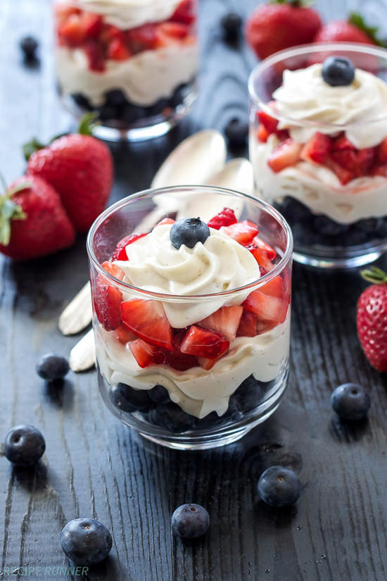 Layers of strawberries, blueberries, and delicious lightened-up no bake vanilla cheesecake, are the perfect combination in these patriotic parfaits!