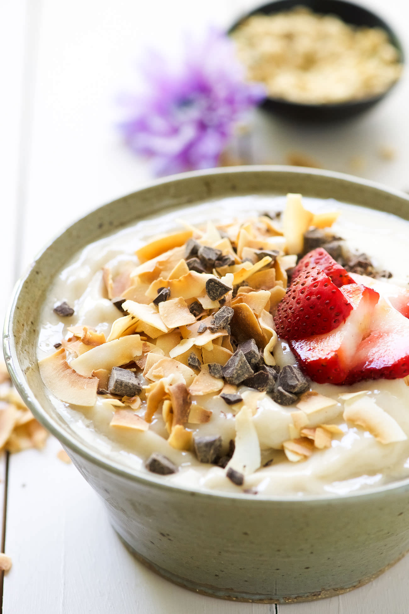 Dark Chocolate and Toasted Coconut Smoothie Bowl is a nutritious and fun twist on a smoothie! Filled with tropical flavors of banana and coconut and topped with dark chocolate, fruit, granola and chia seeds! 