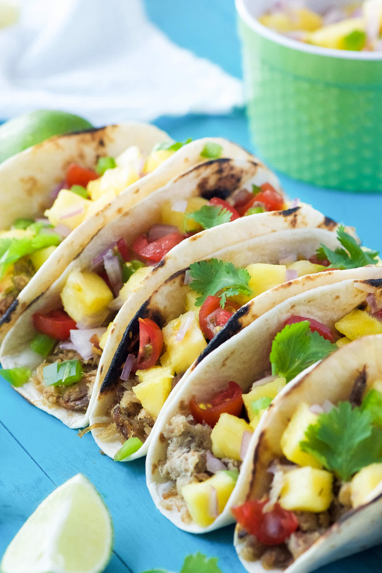 Hawaiian BBQ Pork Tacos are filled with crispy, spiced pork and topped with an irresistible and juicy Pineapple Pico de Gallo! The ideal summer street taco! 