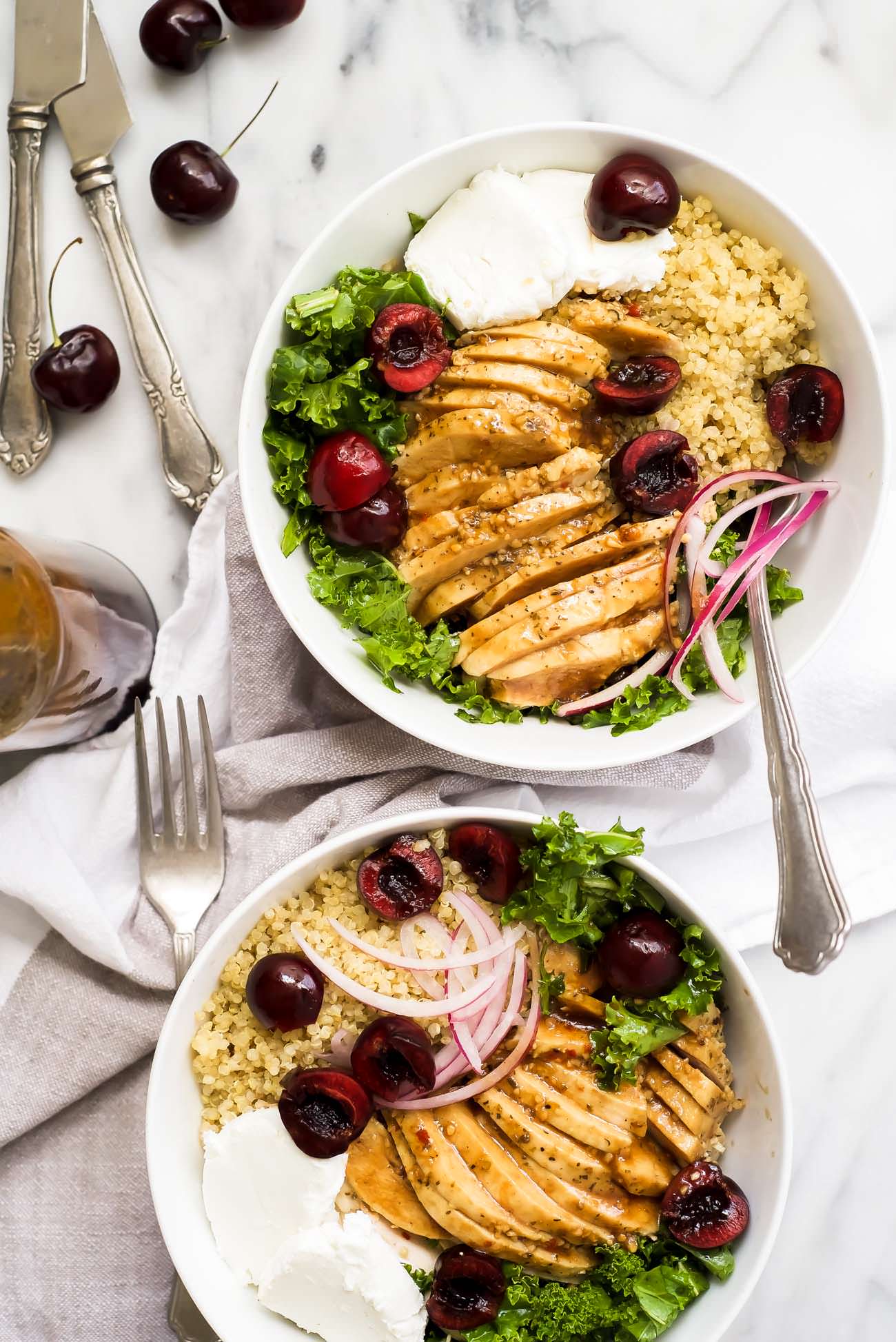Honey Balsamic Glazed Chicken Quinoa Bowls are a hearty and flavor meal! Juicy chicken is coated in a sticky, sweet balsamic glaze then paired with fluffy quinoa, creamy goat cheese, and fresh cherries. A perfect make ahead meal!