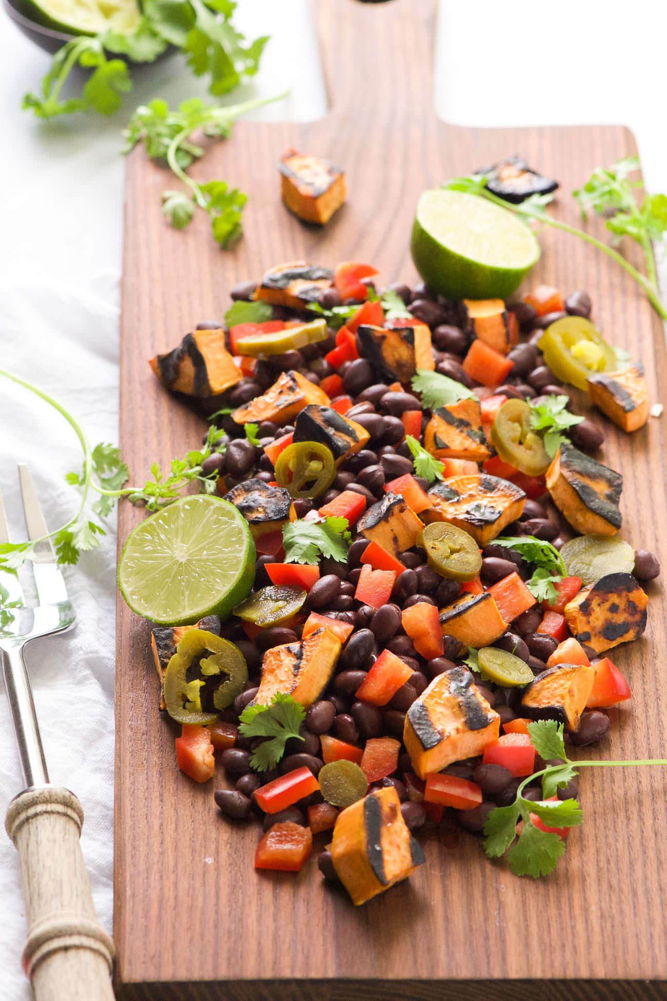 Take your dinner outside with this Southwestern Grilled Sweet Potato Salad! Sweet potatoes caramelize on the grill and then mixed with black beans, charred corn, jalapenos, red pepper, onion and dressed with lime and cilantro. Try it hot off the grill or chilled - can't go wrong either way!