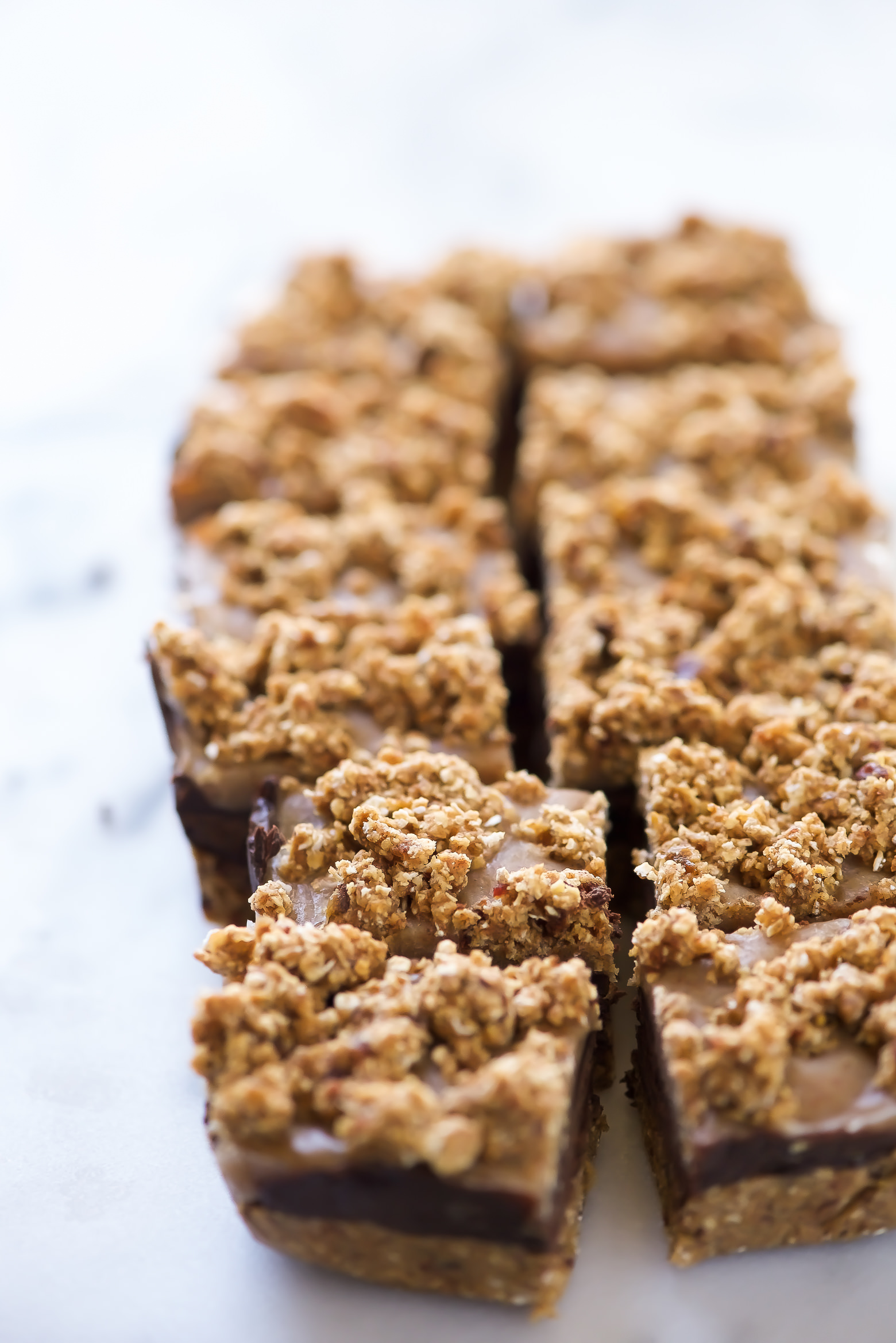 These No Bake Salted Caramel Chocolate Oat Bars come together with only 9 wholesome ingredients and are refined sugar-free! They have a cookie dough-like crust, fudge chocolate, salted caramel and sprinkled with sea salt, all for only 150 calories!