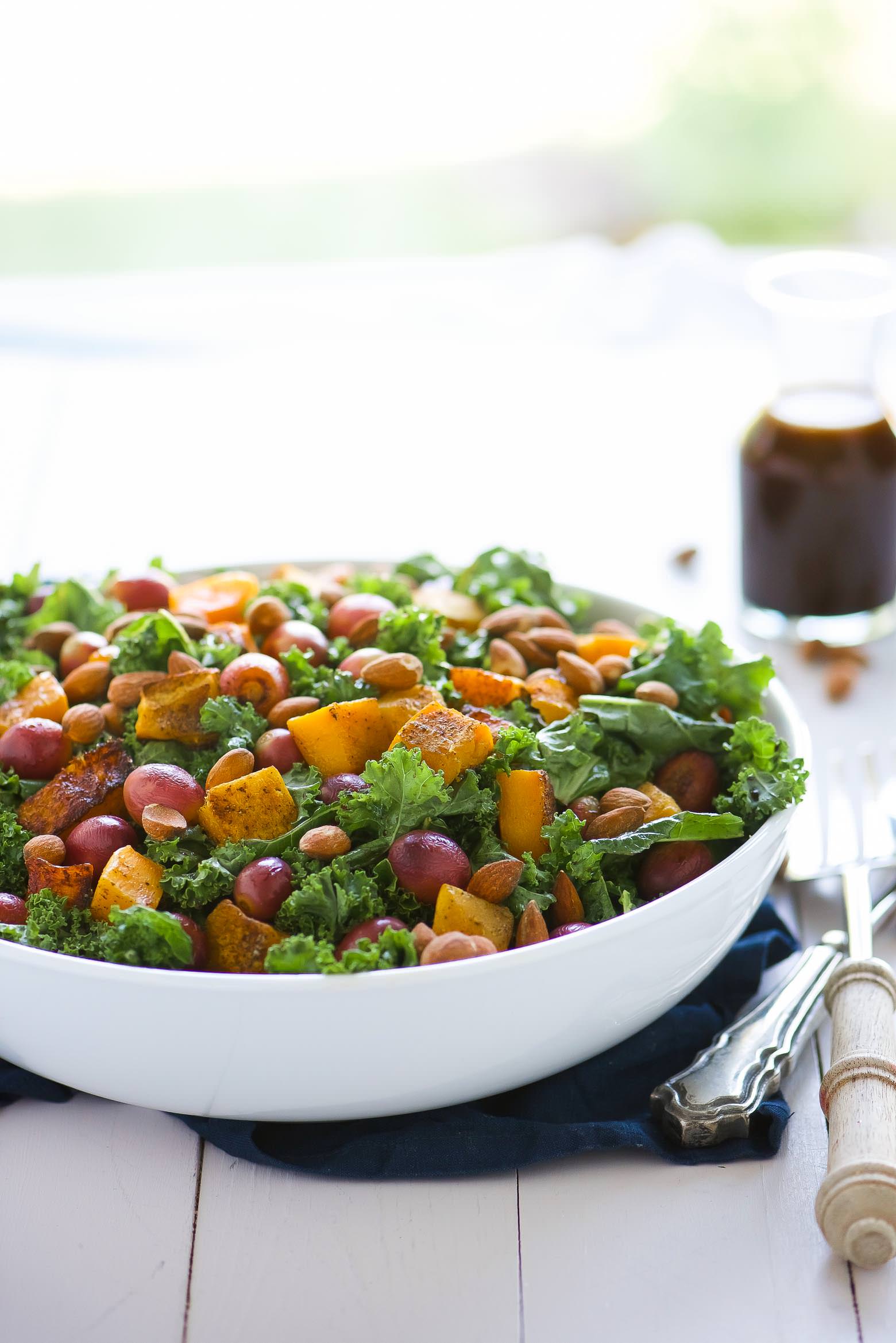 Massaged Kale Salad with Butternut Squash and Roasted Grapes is fall in a dish! It is healthy, simple and perfect for make-ahead lunches! Caramelized butternut squash and roasted grapes mix with balsamic massaged kale for a paleo and vegan friendly salad!