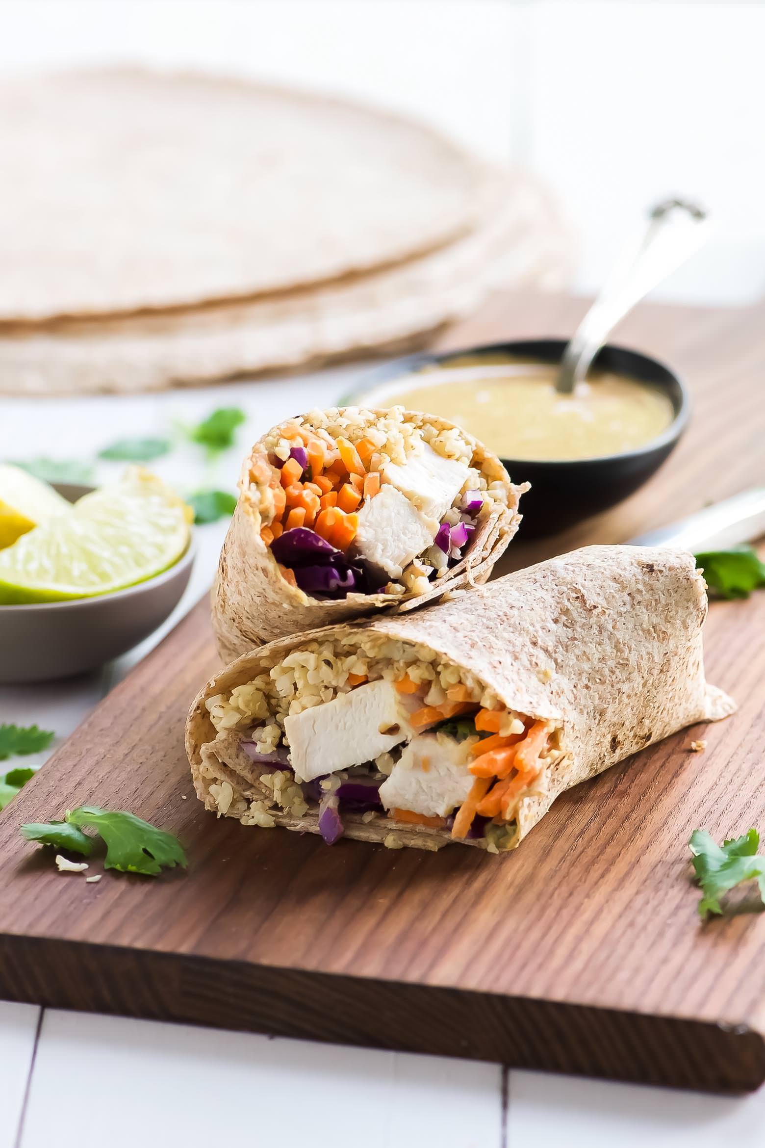 Thai Style Peanut Chicken Cauliflower Rice Wraps are a Starbucks copycat but with a heavy dose of veggies! Chicken, carrots, cabbage and crispy cauliflower rice all wrapped up and served with an addicting Peanut Coconut Sauce!