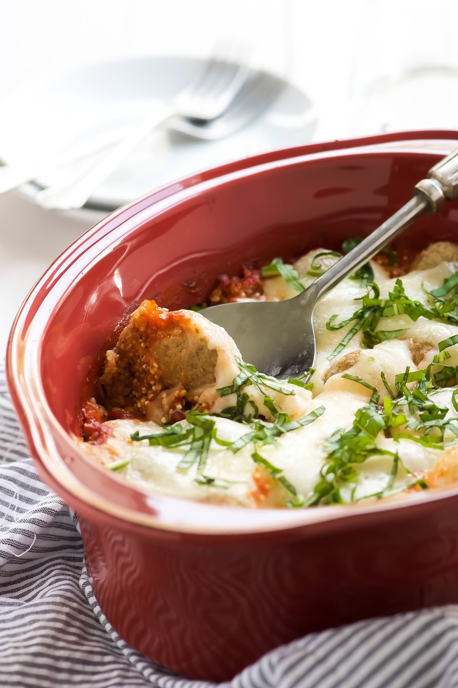 This 5 Ingredient Caprese Quinoa Bake Recipe is a dinner time savor! It requires no prior cooking and filled with gooey cheese, heart-healthy quinoa, turkey meatballs and fresh basil. It freezes wonderfully so make two!