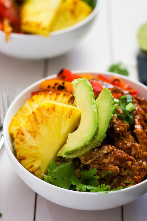 Slow Cooker Hawaiian Pork Burrito Bowls are a dinner saver as they cook all day in a homemade enchilada sauce then topped with sautéed peppers and juicy, seared pineapple!