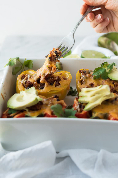 Chicken enchilada cauliflower rice stuffed peppers are filled with southwestern, low carb cauliflower rice and mixed with cheesy, enchilada chicken. perfect to make ahead and bake later!